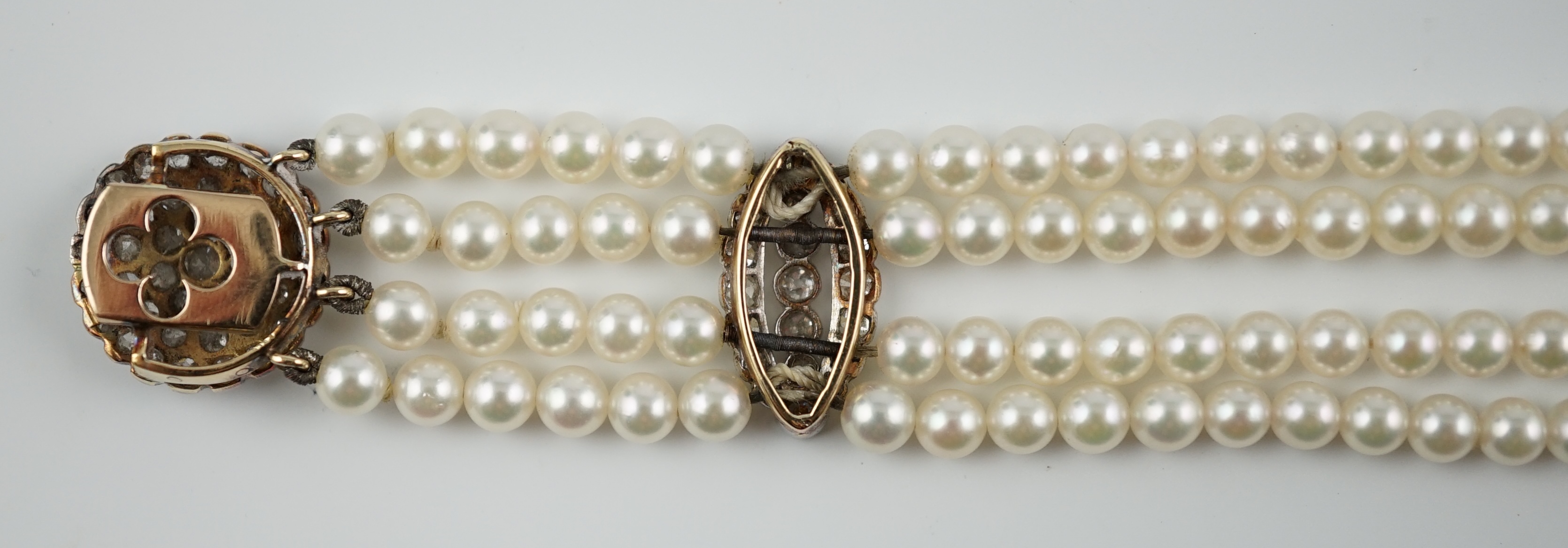 A multi-strand cultured pearl bracelet, with circular diamond cluster set gold clasp